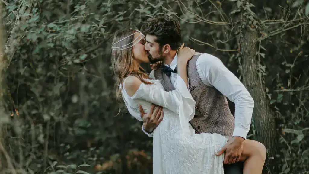 couple kissing at orchard grove outdoor wedding venue near houston